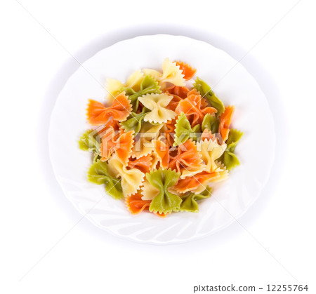 Colored farfalle on white plate. 12255764