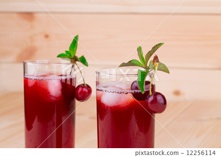 Cherry smoothie on the wooden background. 12256114