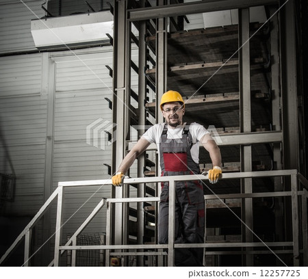 Man in a safety hat on a factory 12257725
