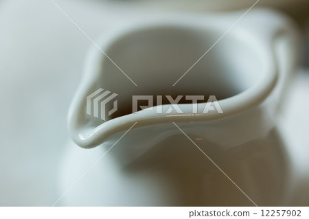 Jug of fresh milk close up, shallow depth of field, with noise 12257902