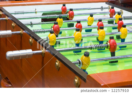 Table football game with yellow and red players 12257910