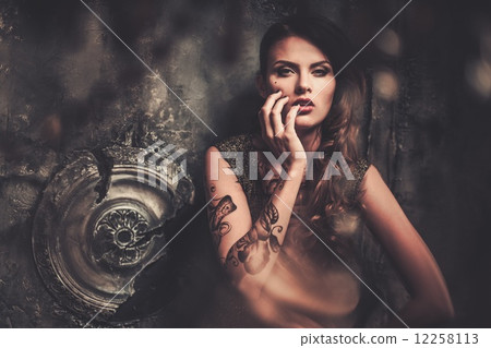 Tattooed beautiful woman in old spooky interior 12258113
