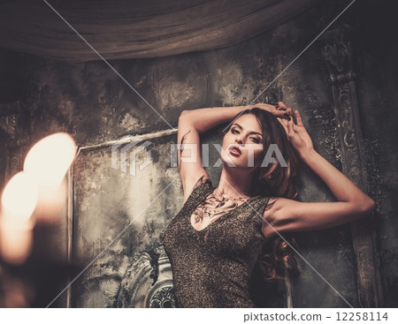 Tattooed beautiful woman in old spooky interior Tattooed beautiful woman in old spooky interior 12258114