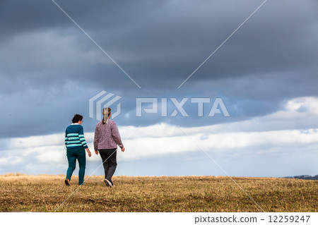 Women Mother Daughter Walking Outdoors Women Mother Daughter Walking Outdoors 12259247