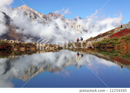 Autumnal leaves reflected in Happo Pond and Hakuba Miyama 12259385