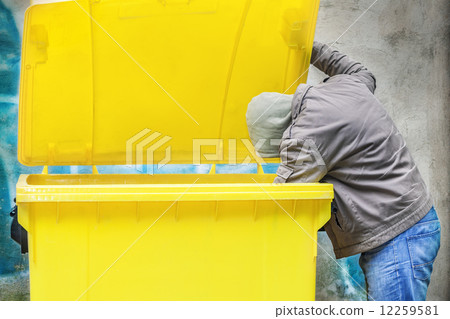 Homeless near garbage container 12259581