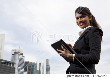 Businesswoman using tablet outdoors 12262045