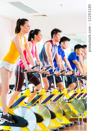 Asian people in spinning bike training at fitness gym 12263180