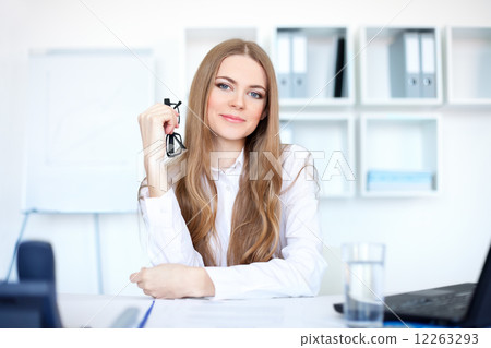 Portrait of beautiful young business woman sitting at desk in br Portrait of beautiful young business woman sitting at desk in br 12263293