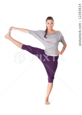 Young woman doing yoga exercise Utthita Hasta Padangustasana 12263614