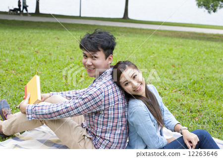 Young Asian couple in a park. Young Asian couple in a park. 12263646