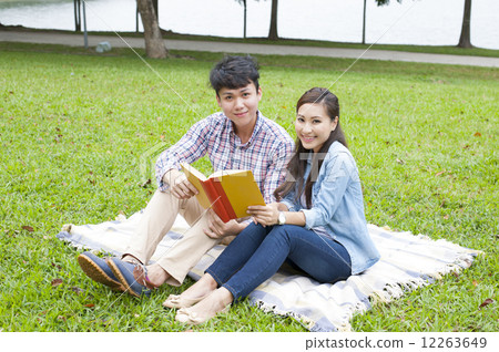 Young Asian couple in a park. Young Asian couple in a park. 12263649