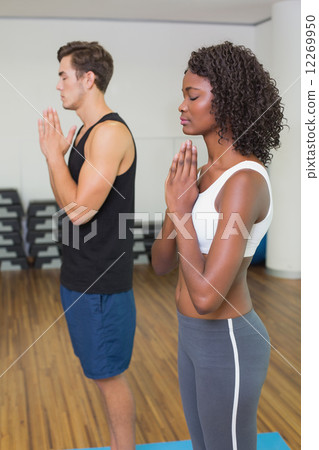 Fit couple standing with hands together 12269950