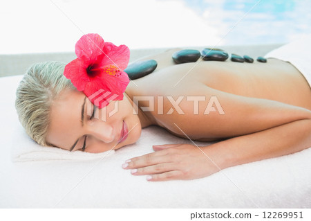 Beautiful woman receiving stone massage at health farm 12269951