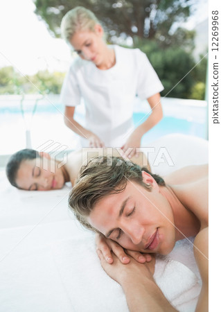 Couple enjoying massage at health farm 12269968