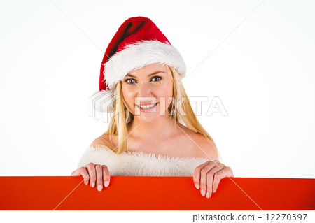 Festive cute blonde holding poster 12270397