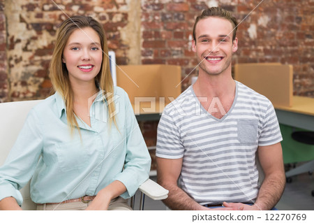 Smiling casual colleagues in office 12270769