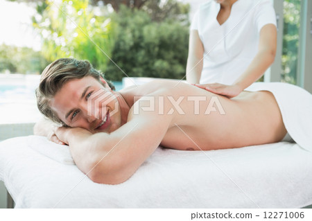 Handsome man receiving back massage at spa center Handsome man receiving back massage at spa center 12271006