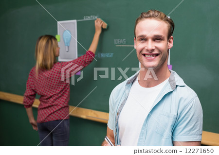 Creative business people at work against blackboard 12271650