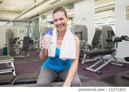 Fit brunette drinking from sports bottle 12271802