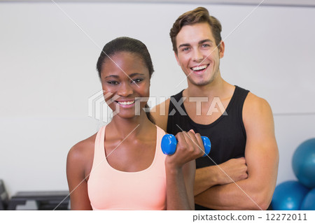 Personal trainer and client smiling at camera Personal trainer and client smiling at camera 12272011