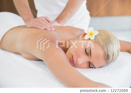 Woman receiving back massage at spa center Woman receiving back massage at spa center 12272089