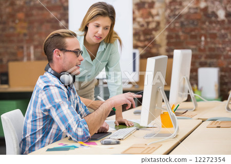 Concentrated photo editors using computer in office Concentrated photo editors using computer in office 12272354