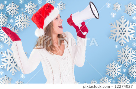 Composite image of festive blonde shouting through megaphone 12274027