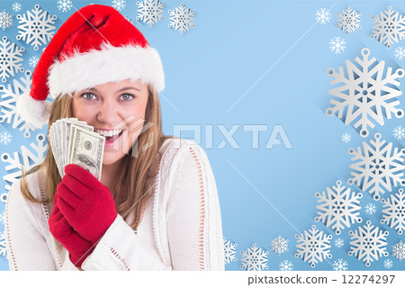 Composite image of festive blonde showing fan of dollars 12274297