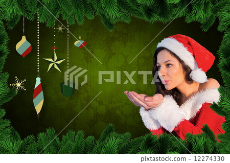 Composite image of pretty girl in santa outfit blowing 12274330