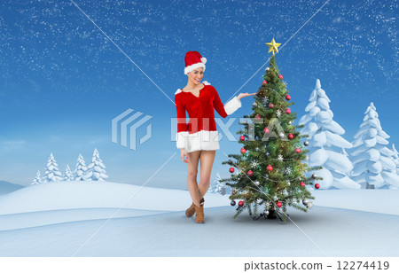 Composite image of pretty santa girl presenting with hand Composite image of pretty santa girl presenting with hand 12274419