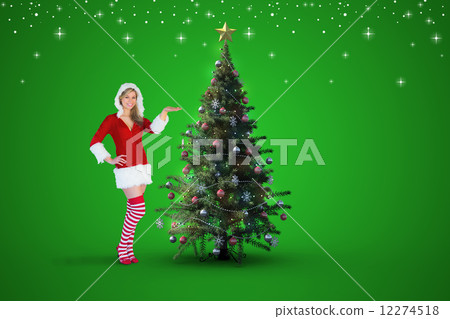 Composite image of pretty girl presenting in santa outfit 12274518