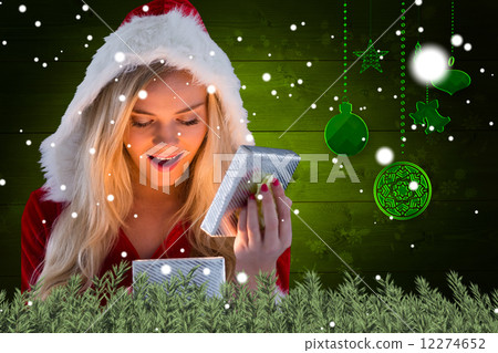 Composite image of sexy santa girl opening gift 12274652