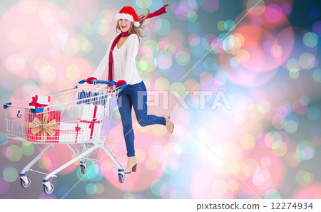 Composite image of festive blonde pushing trolley full of gifts Composite image of festive blonde pushing trolley full of gifts 12274934