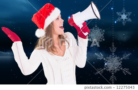 Composite image of festive blonde shouting through megaphone 12275043