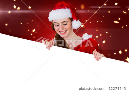 Composite image of pretty girl in santa costume showing card 12275243