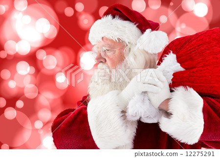 Composite image of santa claus carrying sack 12275291
