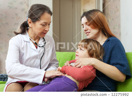 pediatrician doctor examining baby in home 12275992