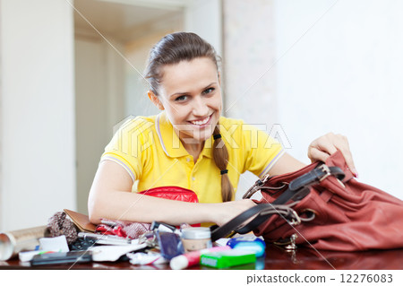 Happy girl founded thing in handbag Happy girl founded thing in handbag 12276083