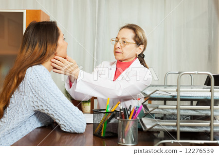Doctor touching gland of female patient Doctor touching gland of female patient 12276539