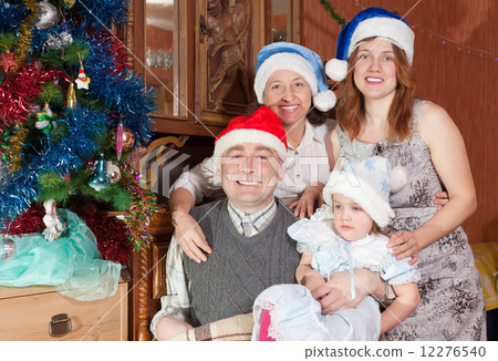 Portrait of happy family in christmas hats Portrait of happy family in christmas hats 12276540