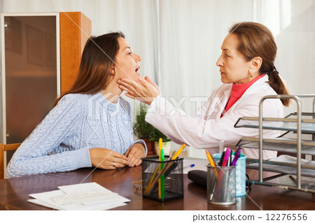 Doctor examining girl patient Doctor examining girl patient 12276556