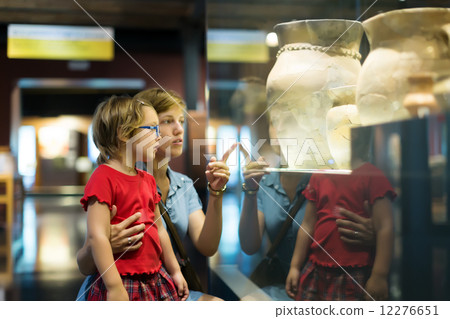 mother and child looking old amphores in museum 12276651