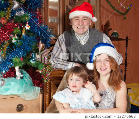 family of three with Christmas tree family of three with Christmas tree 12276668