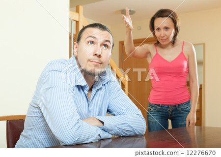 Tired guy listening to his angry woman Tired guy listening to his angry woman 12276670