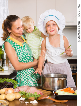 Mother with two daughters cooking 12276762