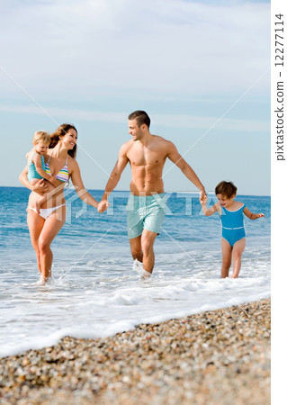 Family with two kids on beach Family with two kids on beach 12277114