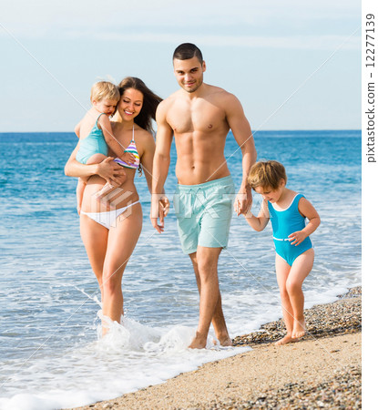 Family of four at the beach 12277139