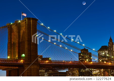 Close up of a pillar of the Brooklyn bridge with flag at night 12277624