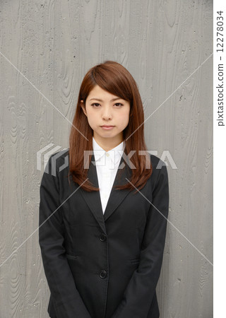 A business woman standing in an office town A business woman standing in an office town 12278034